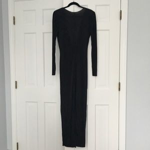 Black long-sleeved floor length dress.